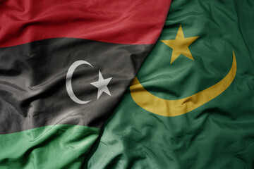 big waving national colorful flag of libya and national flag of mauritania . - obrazy, fototapety, plakaty