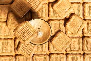 Coffee latte on a pile of crispy square cookies