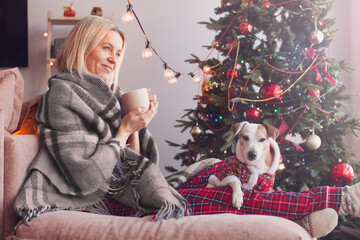 Woman with cup sit couch in house indoors with christmas x-mas atmosphere