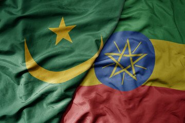 big waving national colorful flag of mauritania and national flag of ethiopia .