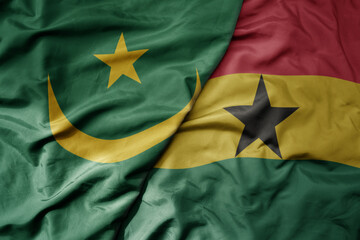 big waving national colorful flag of mauritania and national flag of ghana .