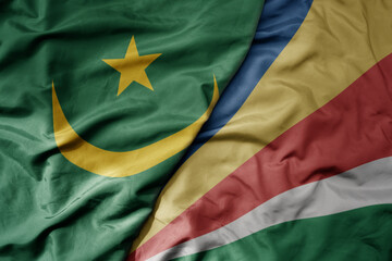 big waving national colorful flag of mauritania and national flag of seychelles .