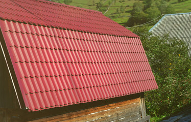 House with a roof made of solid metal sheets, shaped like an old tile