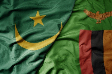 big waving national colorful flag of mauritania and national flag of zambia .