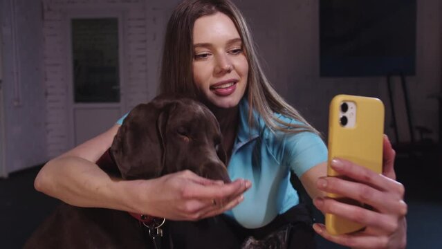 Cute woman taking selfie with her dog