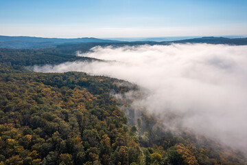 Bird's-eye view of the Taunus forests in the Wisper Valley near Presberg/Germany in autumn with morning fog