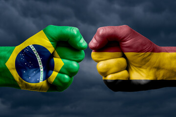BRAZIL vs BELGIUM confrontation, religious conflict. Men's fists with painted flags of BRAZIL and BELGIUM.