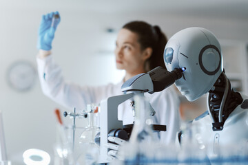 Scientist and robot working together in the lab