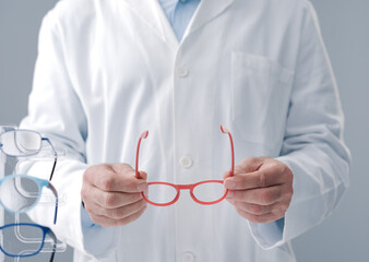 Eye care specialist holding glasses