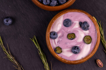 fresh purple and white yogurt with blueberries and blueberry berry flavor