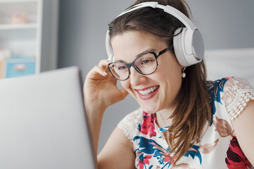 Excited woman watching her favorite videos online