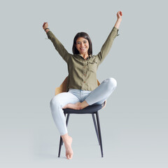 Cheerful woman celebrating with raised arms