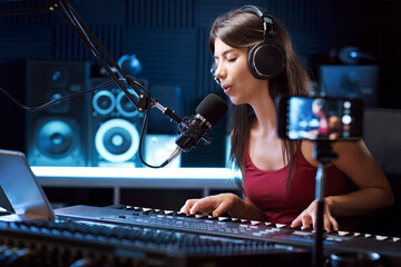 Young artist recording a song and streaming a video