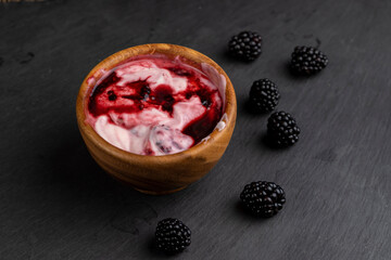 fresh yogurt with crushed juicy blackberries, preparation of yogurt