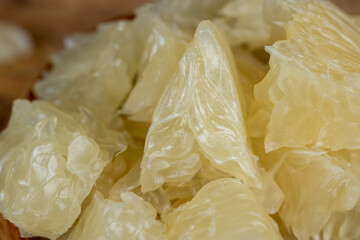 peeled pomelo on the table, close up