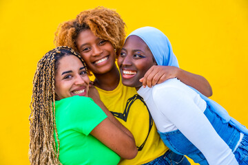 Three multi-ethnic girls posing embracing together
