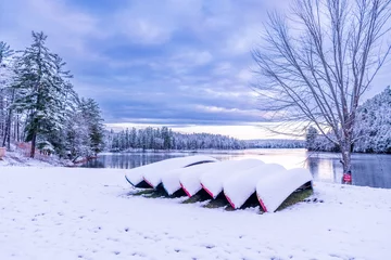 Crédence de cuisine en verre imprimé Canada first snow fall of the year covers canoes on the shore of the ottawa river in  morning