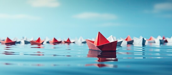 Red paper boat surrounded by white boats on blue background represents teamwork