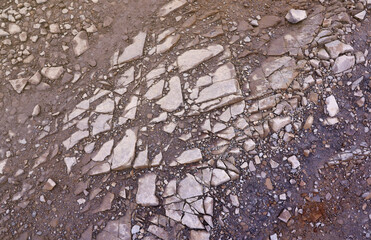 Background of shattered stony stones surface in mountain area. Texture with natural light.