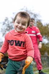 Fototapeta premium Little boy with his father playing as a craftsman and gardener in autumn