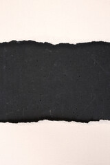 Blank pieces of ripped paper on dark stone background. Contains copy space.