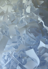 Shredded paper texture background, top view of many white paper strips. Pile of cut paper like box filler for shipping fragile items.