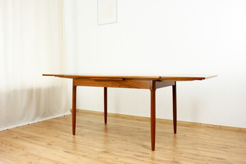 A mid century teak dining table with four chairs from the 50s 60s Danish Design Vintage Dining solid wood Modern antique 50s 60s isolated on white wall in modern living room closeup side front view