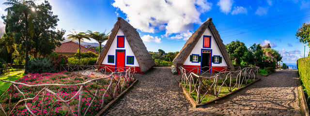 Madeira island travel and landmarks. Folk Museum in Santana town. Charming traditional colorful houses with thatched roofs, popular tourist attraction in Portugal - obrazy, fototapety, plakaty