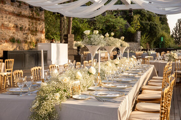 A luxurious, elegantly decorated wedding venue with a sea-view outdoor area. The decoration of the...