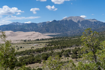 Fototapeta na wymiar Great Sand Dunes National Park in Colorado on a sunny summer day, with mountains in the background