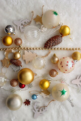 Various colorful Christmas oranments and white faux fur blanket. Top view.