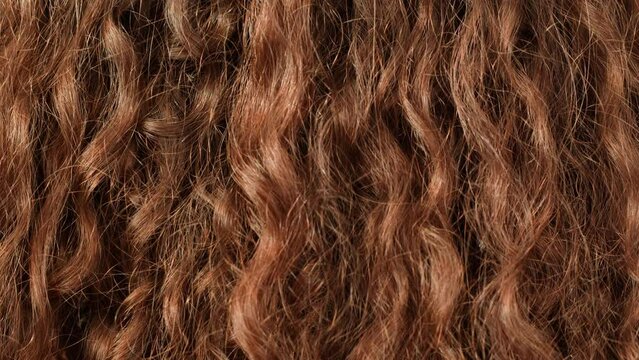 Brown brunette curly wavy hair texture close-up macro. Hairstyle. Body spa and relax ritual self and hair care