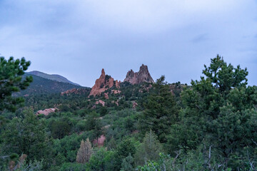 A view of rock formations in Garden of the Gods around sunset, in Colorado Springs, CO on a cloudy summer evening 