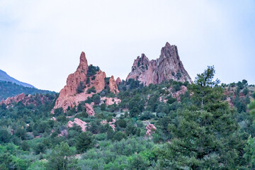 A view of rock formations in Garden of the Gods around sunset, in Colorado Springs, CO on a cloudy summer evening 