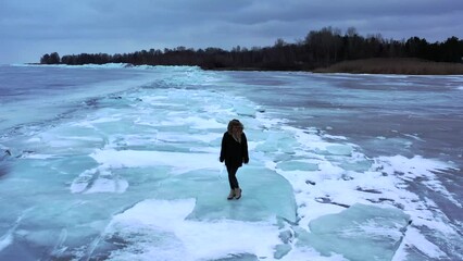 Lake , girl walking on frozen lake, Girl walking on cracked ice of a frozen lake Baikal, Woman walking along the diamond beach in Iceland. Feet on ice, girl walking on frozen lake 