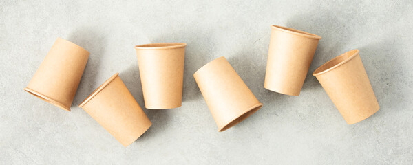 Flat lay composition with eco-friendly paper cups on grey stone background