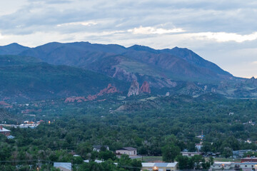 A view of Garden of the Gods from afar at sunset on a cloudy evening in Colorado Springs, CO