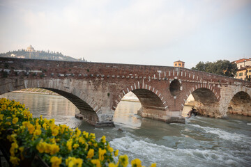 An arched bridge over flowing water - italian medieval landscape