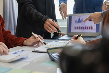 professional businessman Group of confident young businessmen analyze data using computer in a collaborative meeting discussing financial data analysis and business strategy project.