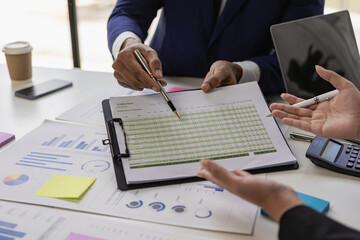 professional businessman Group of confident young businessmen analyze data using computer in a collaborative meeting discussing financial data analysis and business strategy project.
