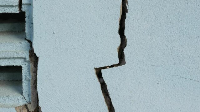 Cracks in the cement wall White cement of buildings damaged by earthquakes.4k