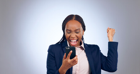 Business woman, winning and phone in studio for success, celebrate profit and bonus promotion on...