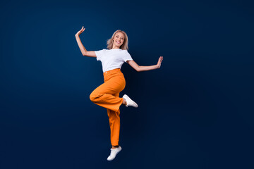 Fototapeta na wymiar Full length photo of stunning cute elegant girl wear trendy outfit jump up empty space isolated on dark blue color background