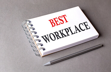BEST WORKPLACE word on notebook on grey background