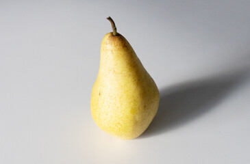 Sunny Simplicity: Yellow Pear on White Background