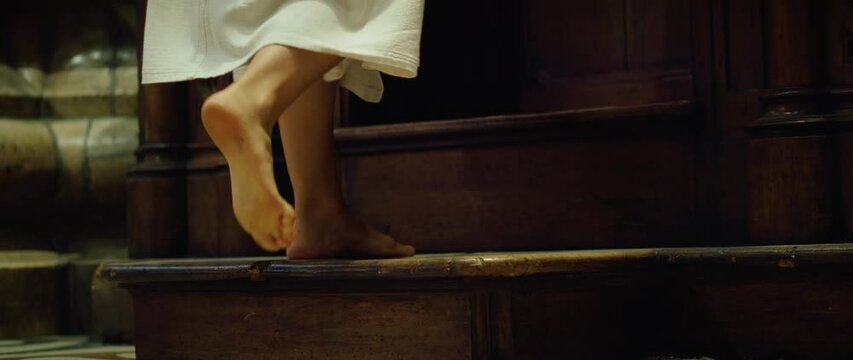 Barefoot pilgrim tramp praying in church. Confession of sins to a priest. The woman came to the priest to repent. Repentance for sins.