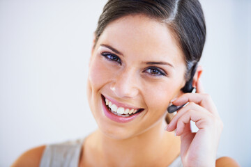 Call center, woman and portrait in studio for communication, telecom questions and customer service support on white background. Face of happy telemarketing consultant with microphone for CRM contact