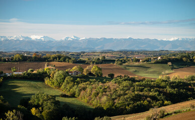 Naklejka premium Countryside landscape in the Gers department in France with the Pyrenees mountains in the background 