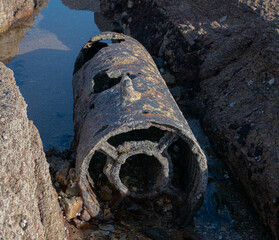 November 2022, the remains of a shell in rear view, dating from the Second World War in the reefs of the beach of La Sauzaie, Vendée FRANCE.