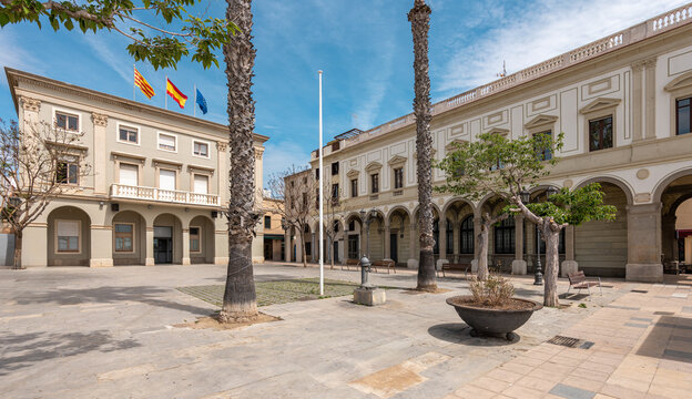 Town hall with flags and paved square in Vilassar de Mar